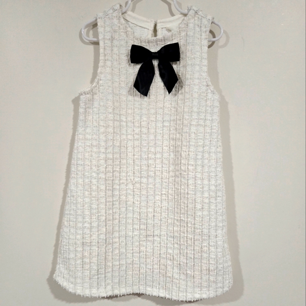 Charming White Sleeveless Dress with Black Bow